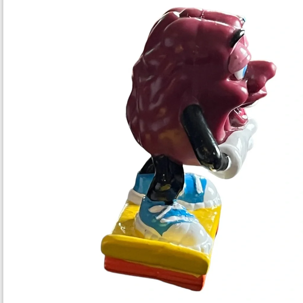 Vintage 1980s California Raisins Figure Riding a Skateboard Cake Topper